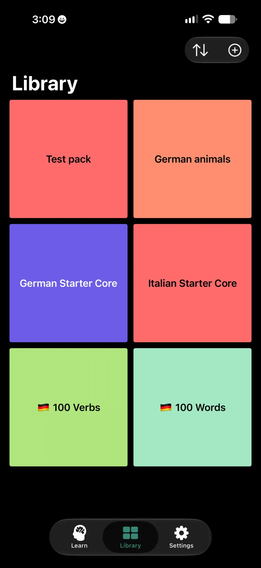 Library screen showing six packs in a grid, with a plus button at the top right to create a pack.