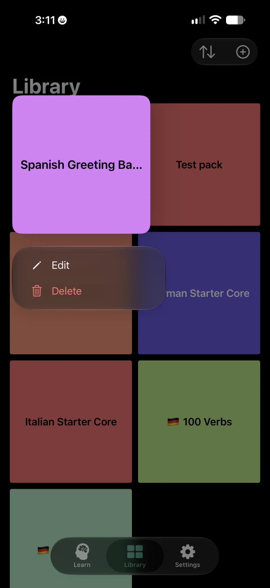 Library screen with the Spanish Greeting pack selected and a menu showing Edit and Delete options.